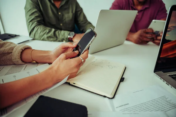 Four workers gathered for discussion researching on smartphone and laptops brainstorming ideas. — 图库照片