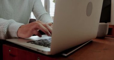 Mixed race business man close up typing on laptop finishing replying to emails working from home