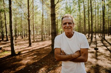 Portrait of young caucasian father exercising in the forest