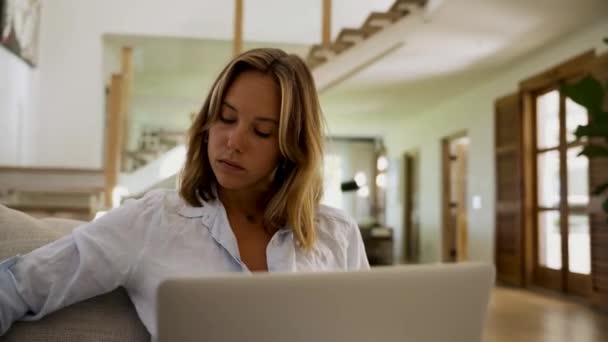 Blanke vrouw werken vanuit huis typen op laptop lezen opdracht richtlijnen — Stockvideo