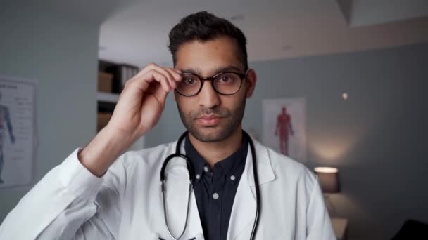 Mixed race male doctor standing in office wearing stethoscope — Stock Video