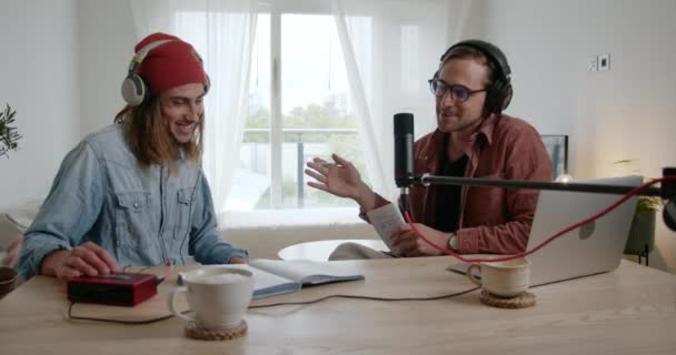 Amici maschi caucasici che registrano podcast in soggiorno con attrezzatura tecnica — Video Stock