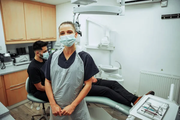 Καυκάσια νοσοκόμα στέκεται στο γραφείο ιατρών απολαμβάνοντας τη διαβούλευση με τον αρσενικό πελάτη — Φωτογραφία Αρχείου