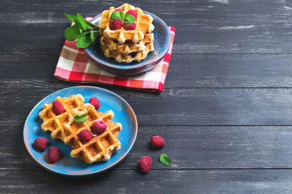 Belgian lush round waffles with fresh raspberries — стокове фото