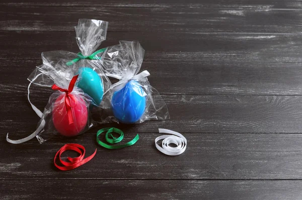 Three chicken easter eggs in festive packaging with ribbons — Stock Photo, Image