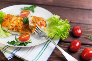 white plate glass portion of the baked cod fish