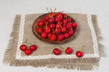 Red berries cherries on lacy napkin