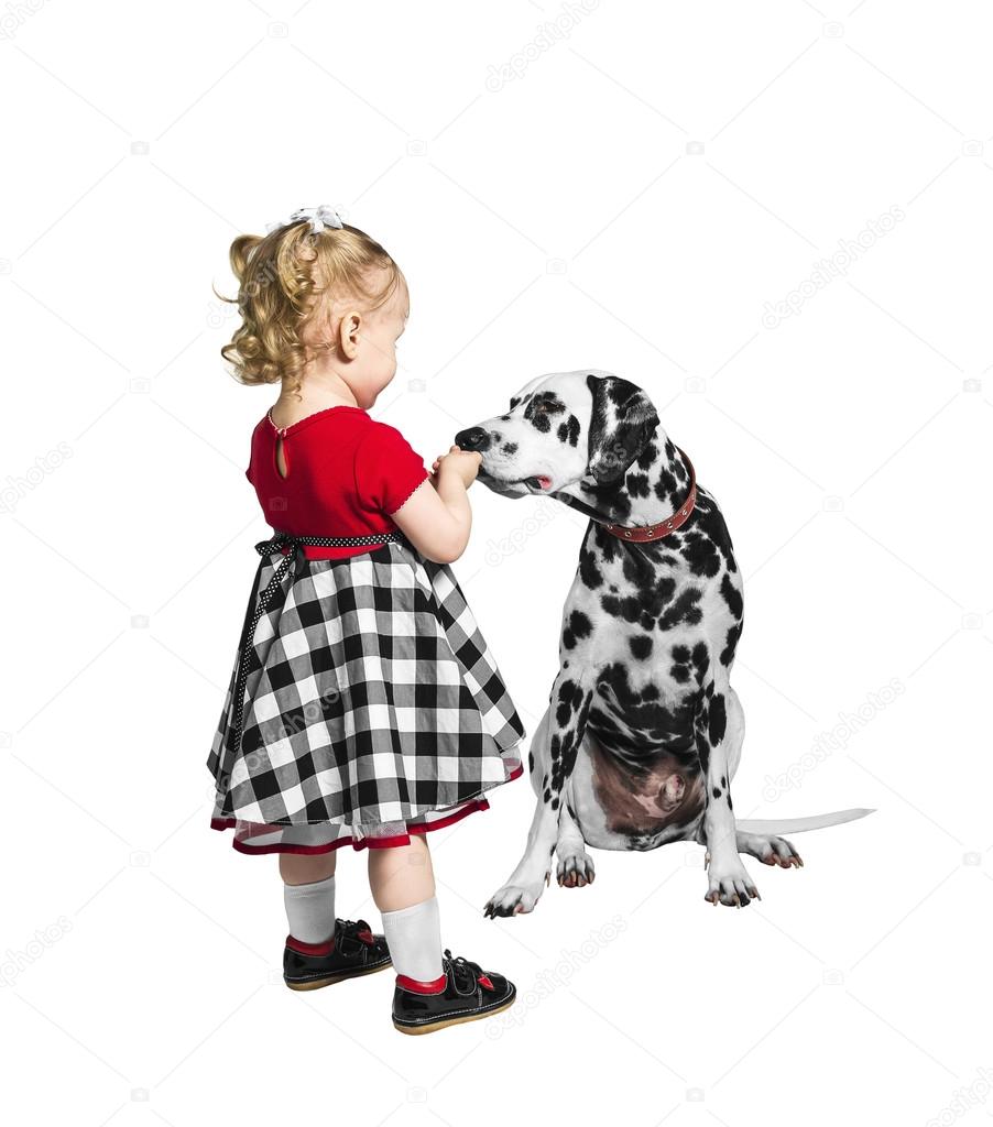 Little girl and a dog dalmatian
