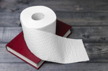 hardcover red cover to read and white embossed roll of toilet pa