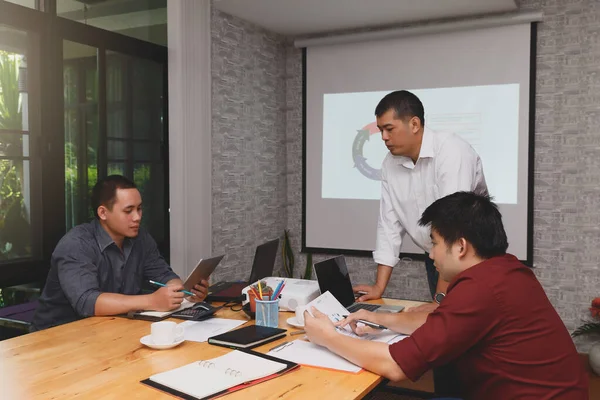 Business team meeting and discussing project plan. Businessmen discussing together in meeting room. Professional investor working with business project together.
