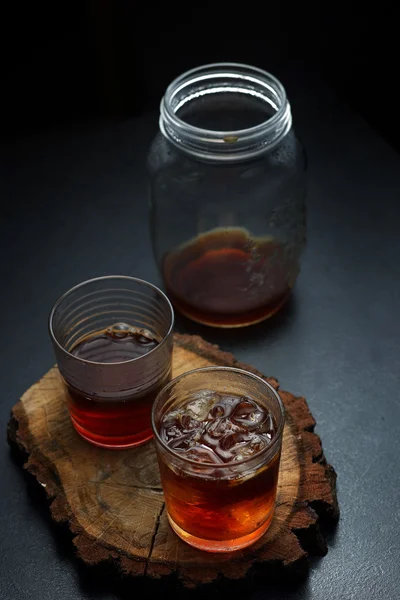 Filter coffee in glasses of hot and cold on a wooden board on dark background with copy space. — Stock Photo, Image