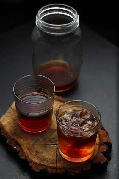 Filter coffee in glasses of hot and cold on a wooden board on dark background with copy space. — Stock Photo, Image