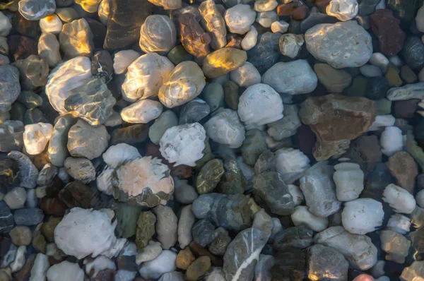 Naturally rounded gravel at sea shore — Stock Photo, Image