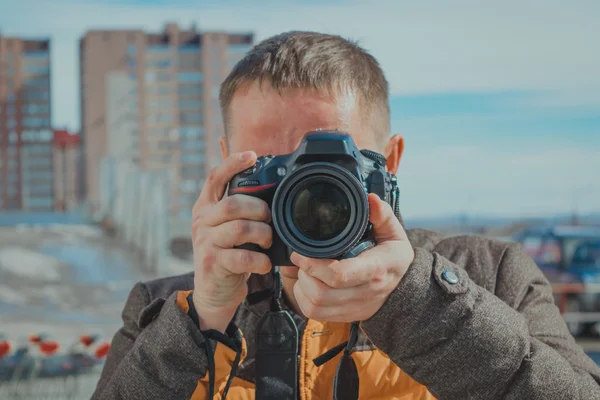 Young man with a camera — Stock Photo, Image