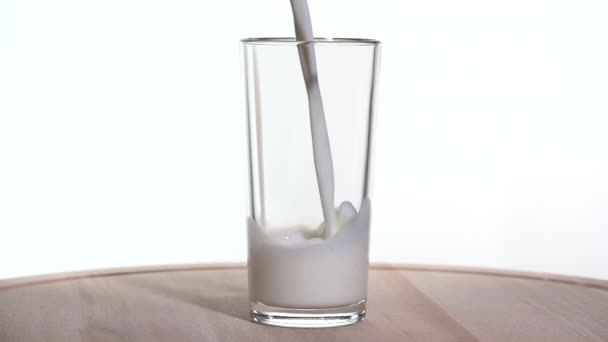 Milk is poured into a glass. Slow motion 250fps — Stock Video