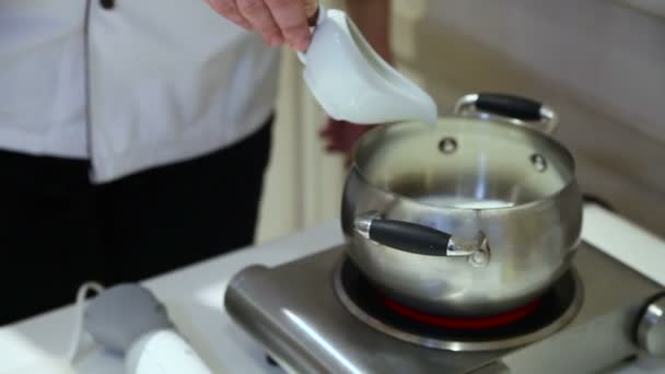 Chef-kok giet suiker in de pan — Stockvideo