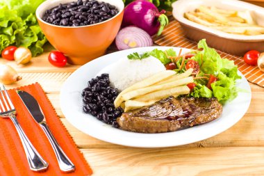 Grilled meat, rice and beans. clipart