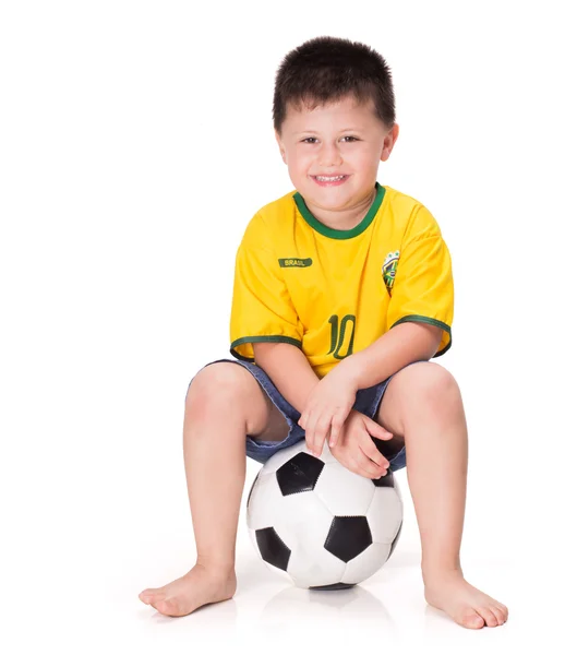 Niño con una pelota de fútbol vestido con camisa de fútbol — Foto de Stock