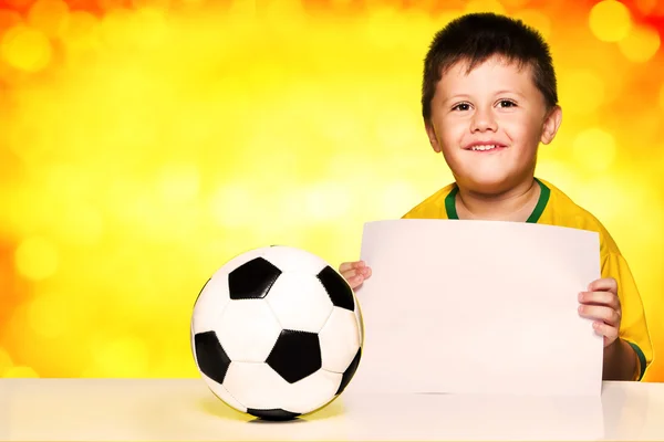 Boy in brazilian national football shirt and ball — Stock Photo, Image