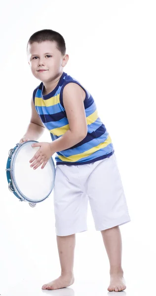 Happy boy in colorful shirt with tambourine — Stock Photo, Image