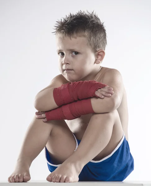 Child boxer in shorts and bandages — Stock Photo, Image