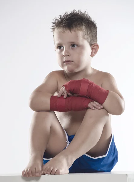 Child boxer in shorts and bandages — Stock Photo, Image