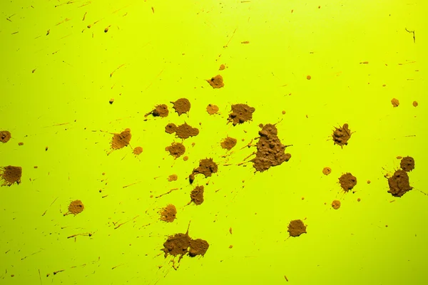 Splash of clay on  yellow — Stock Photo, Image