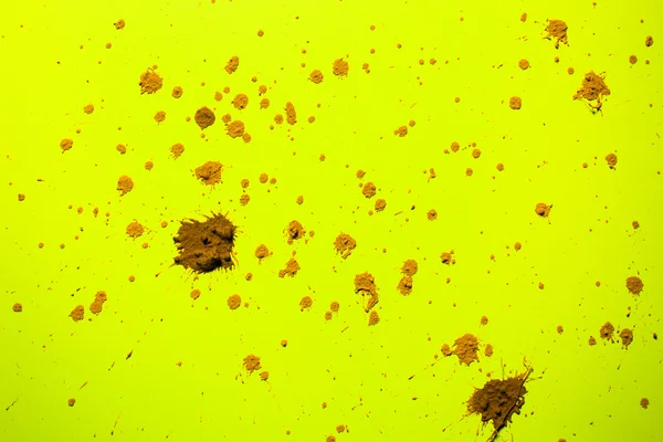 Splash of clay on  yellow — Stock Photo, Image