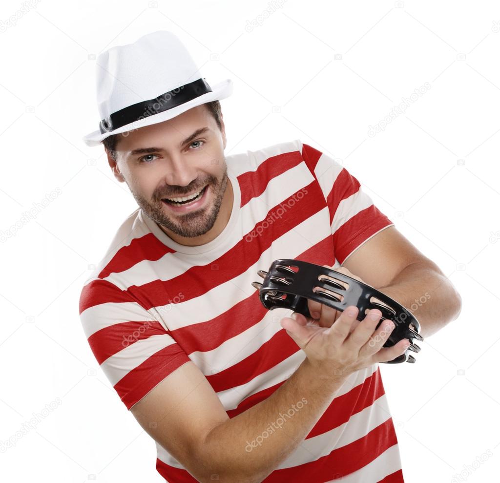 Happy man in colorful shirt with tambourine