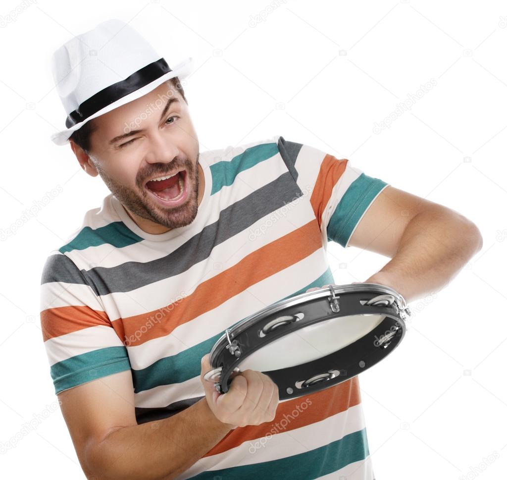 Happy man in colorful shirt with tambourine