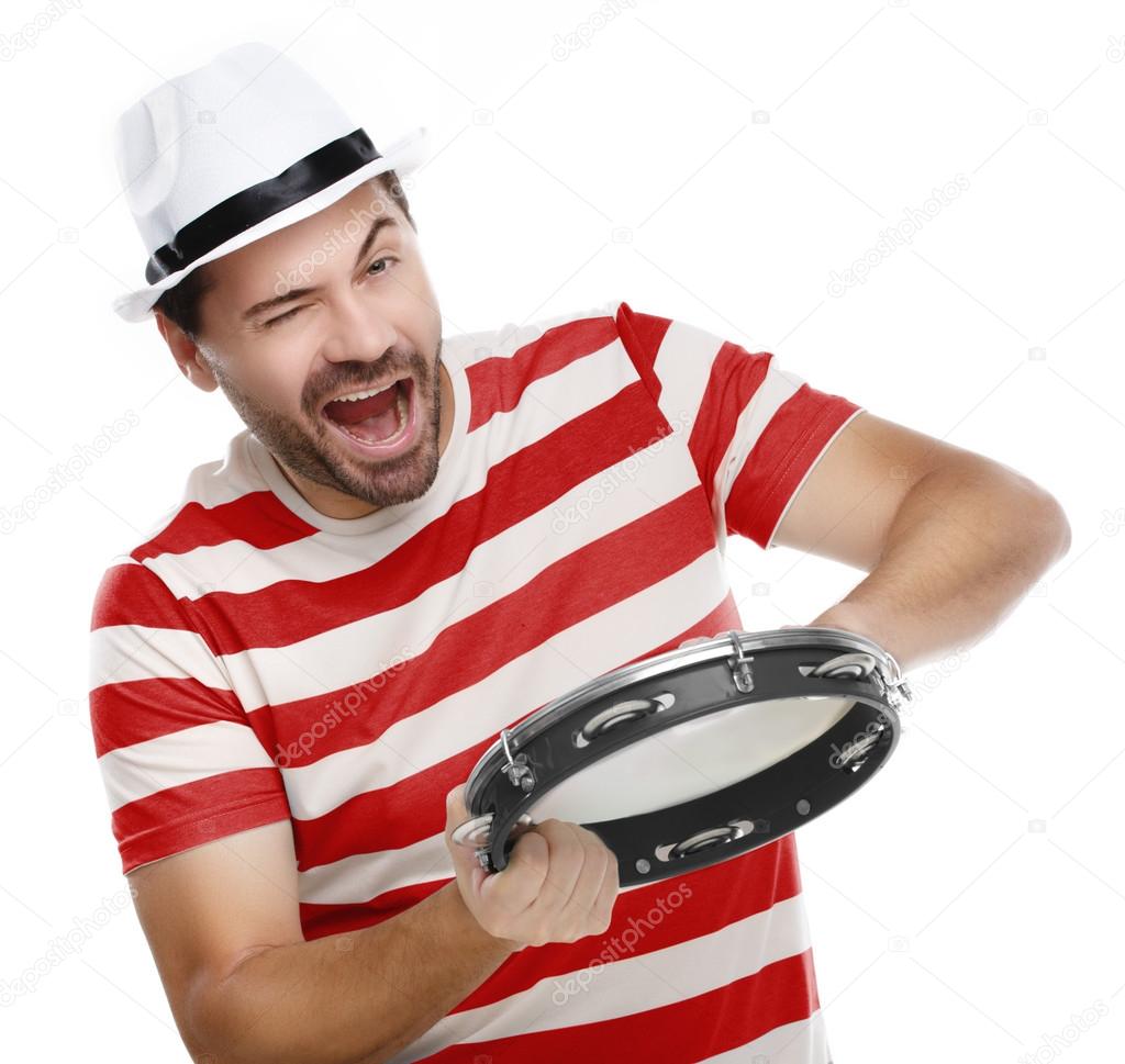 Happy man in colorful shirt with tambourine