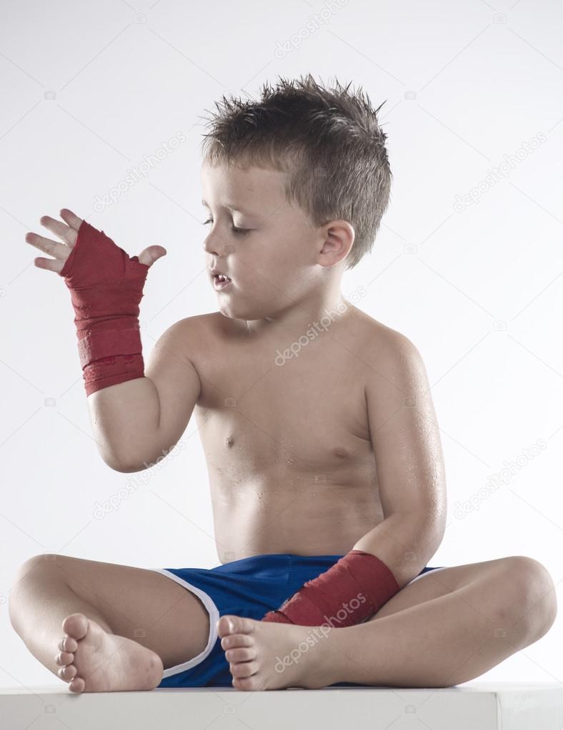 Child boxer in shorts and bandages