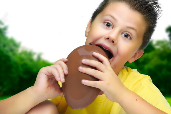 Boy eating chocolate egg