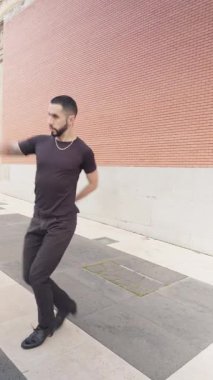 Sakallı ve dövmeli genç erkek dansçı Madrid, İspanya 'da bir şehir caddesinde enerjik ve etkileyici flamenko hareketleri sergiliyor.