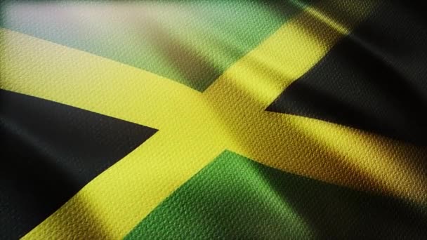 4k Jamaica La bandera nacional arruga el viento en el fondo del lazo sin costuras jamaicano. — Vídeo de stock