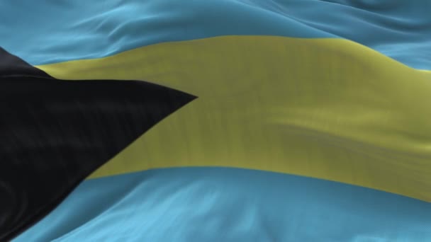 4k Bahamas Bandera nacional arrugas lazo viento sin costuras en el fondo del cielo azul. — Vídeo de stock