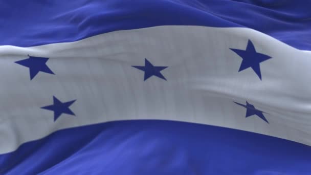 4k Honduras drapeau national rides boucle vent sans couture en fond de ciel bleu. — Video