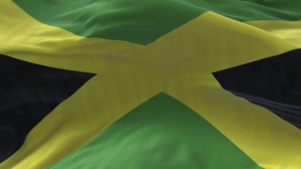 4k Giamaica Bandiera nazionale rughe loop vento senza soluzione di continuità in sfondo cielo blu. — Video Stock