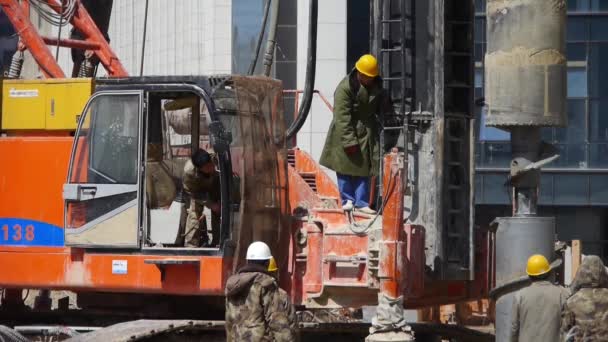 Workman operating heavy machinery rotating gear drillpipe. — Stock Video