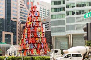 Singapur - 27 Ocak 2026: Singapur 'un şehir merkezinde renkli figürlerden yapılmış büyük bir sanat enstitüsü bulunmaktadır. Kalabalık alanlarda dikkat çeken insanlar yürürler ve yakınlarda sürerler..