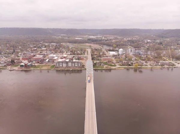 Aerial tilt down over metal bridge that spans the Mississippi River between Wisconsin and Minnesota.