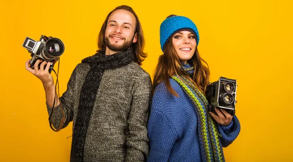 Stylish photographer. Man and Woman with Vintage photo camera. Photojournalist.