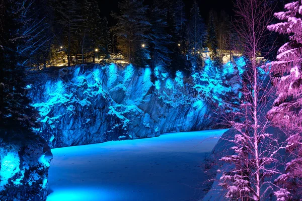Kış gecesi mermer ocağının renkli aydınlanması. Ruskeala, Karelia.