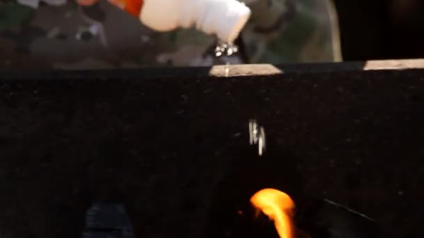 Man kindles coals in Grill — Stock Video