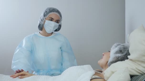 Medizin und Gesundheitskonzept. Ein Arzt versorgt einen Patienten in einem Krankenhaus. Der Arzt kümmert sich um Menschen aus covid-19 — Stockvideo