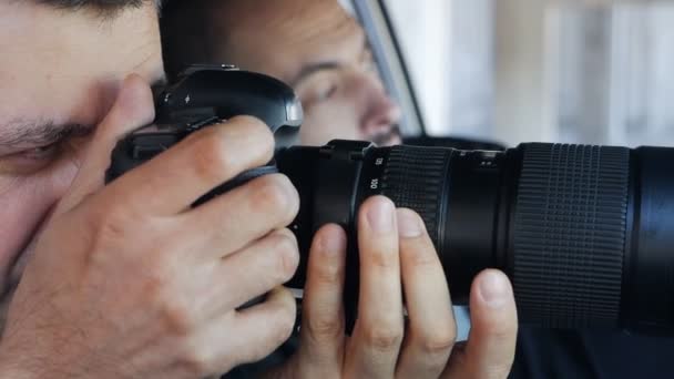 Paparazziler ya da dedektifler arabada otururken gizlice bir şeyin fotoğrafını çekerler. Bir makale için delil ya da materyal toplamak — Stok video
