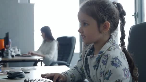 Adorable preschool child working on computer at table in office.Little business lady — Stock Video