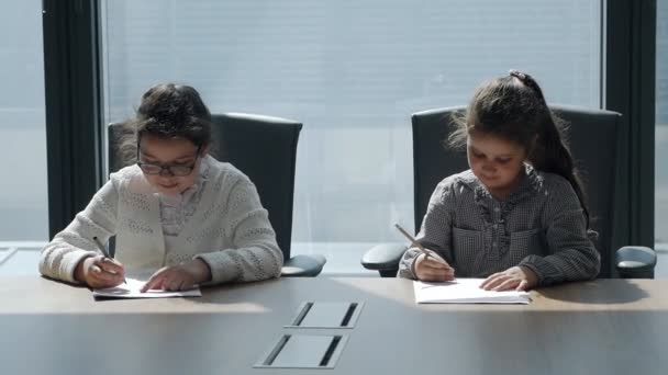 Crianças trabalhando com documentos no local de trabalho, em um escritório moderno — Vídeo de Stock