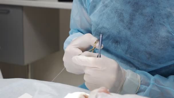 Close up - the hands of a professional dentist performing dental procedures or dental implants for a patient — Stock Video