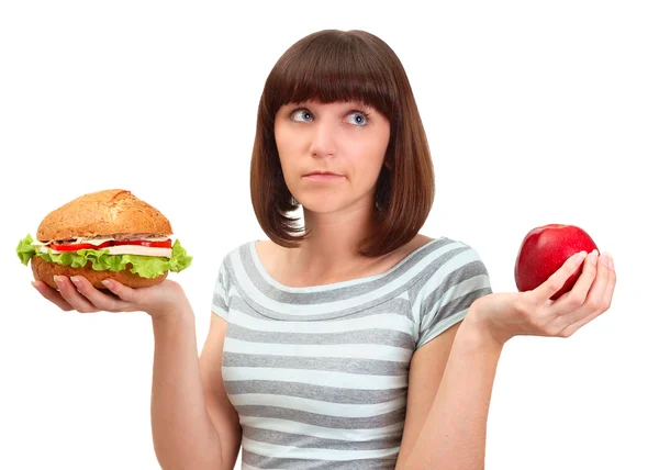 Retrato de menina bonita decidir o que comer hambúrguer ou Fotos De Bancos De Imagens